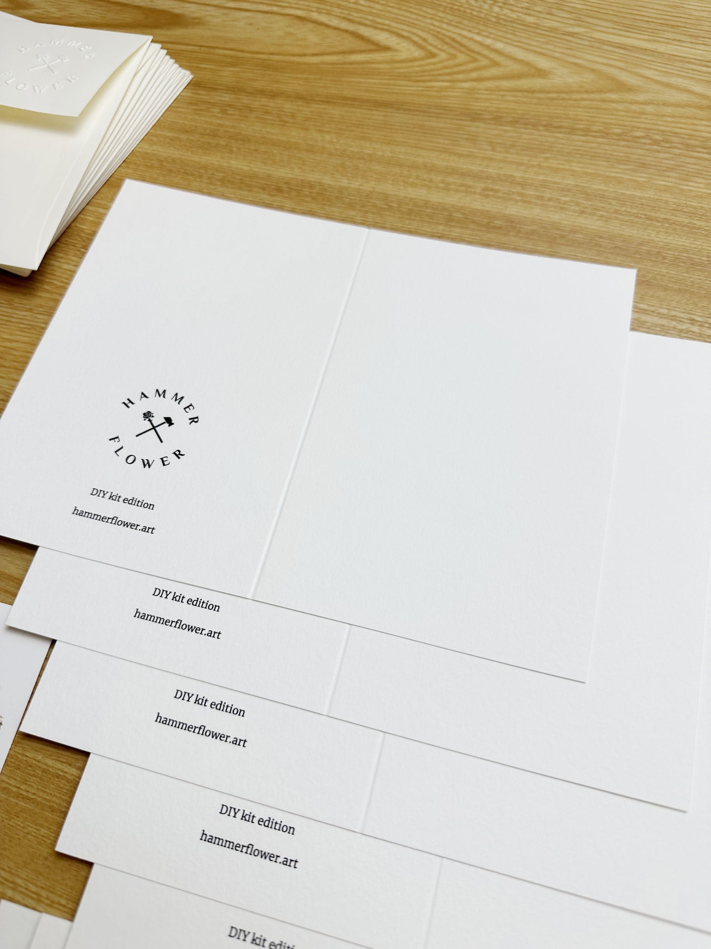 Scored blank watercolor cards with HammerFlower branding on the back