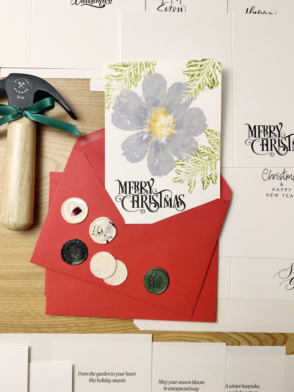 Flower-hammered Christmas card with greenery, red envelopes, wax seals and a HammerFlower hammer